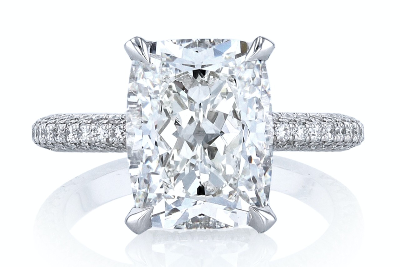 a white gold engagement ring with side stones and a radiant cut center stone