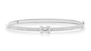 a delicate white gold chain bracelet featuring a bar of channel set diamonds