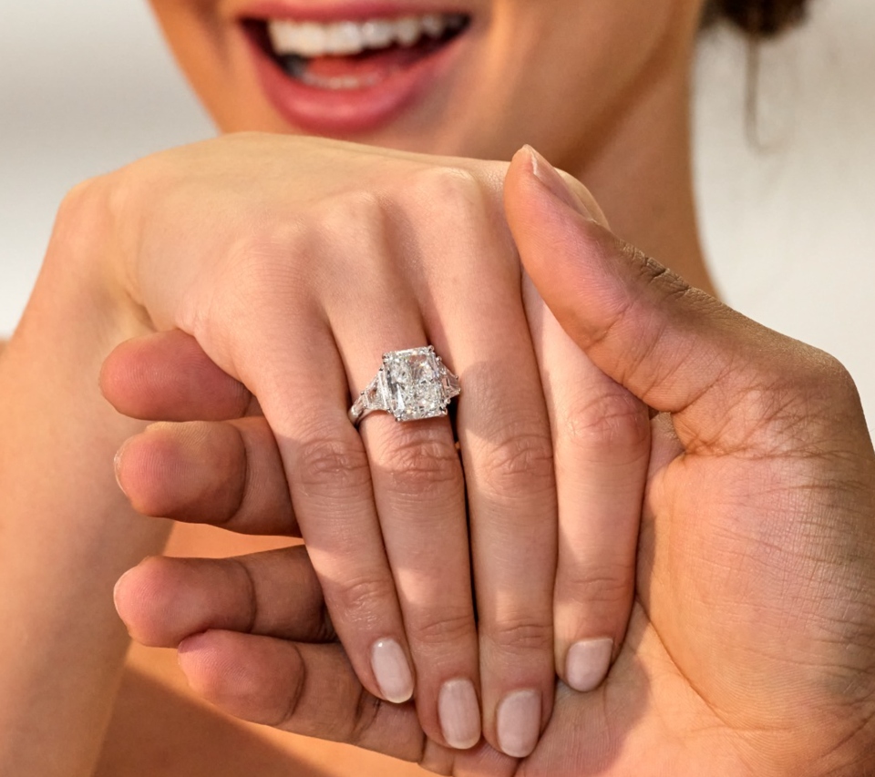 Woman excited with a gorgeous platinum diamond engagement ring on her hand