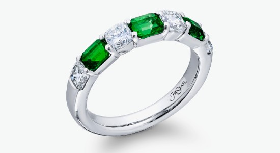 a platinum fashion ring featuring both emeralds and clear diamonds