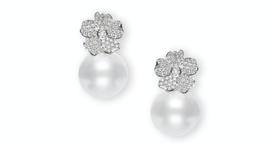 a pair of pearl stud earrings with cherry blossom motifs