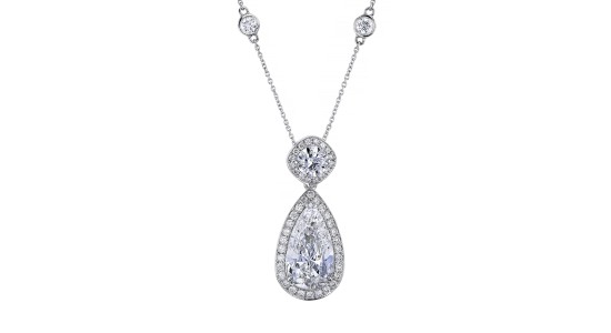 a platinum pendant necklace with a pear shape diamond center stone