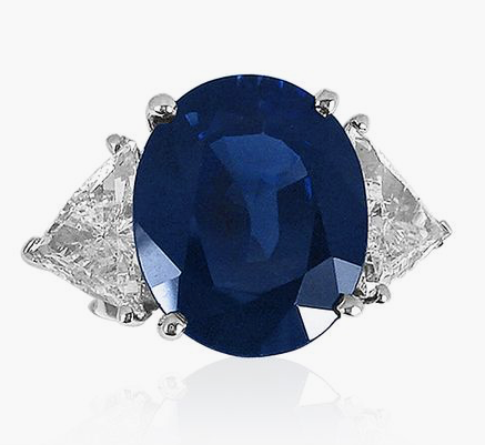 Alson Signature Collection, this Platinum, Sapphire and Diamond Engagement Ring Features an Oval Blue Sapphire =10.89 Carats, Two Trilliant Diamonds =2.40cts Total Weight, SI2 Clarity, F Color | Alson Jewelers